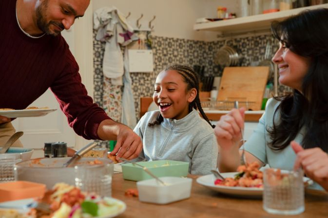 Family having a meal smiling