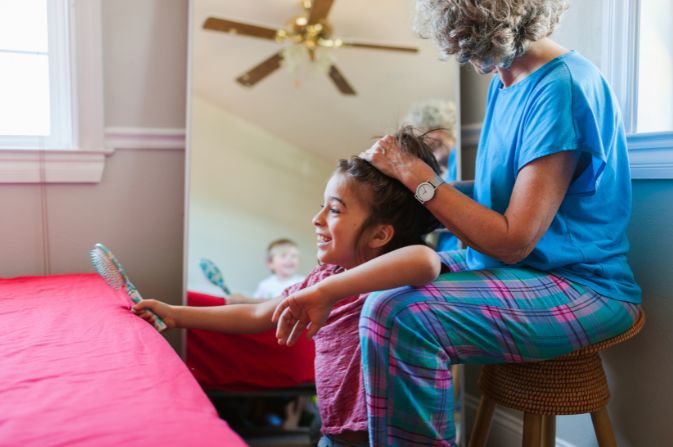 Woman and child completing hairstyle DfE image 2026